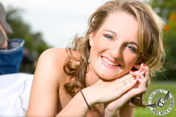 Austin senior portrait close-up of a smiling woman outdoors at Mueller Lake Park in Austin, TX.
