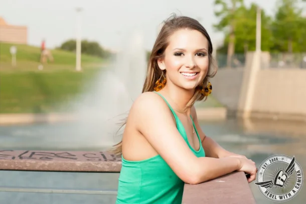 Austin senior portrait of a smiling woman in a turquoise dress at Lady Bird Lake in Austin, TX.