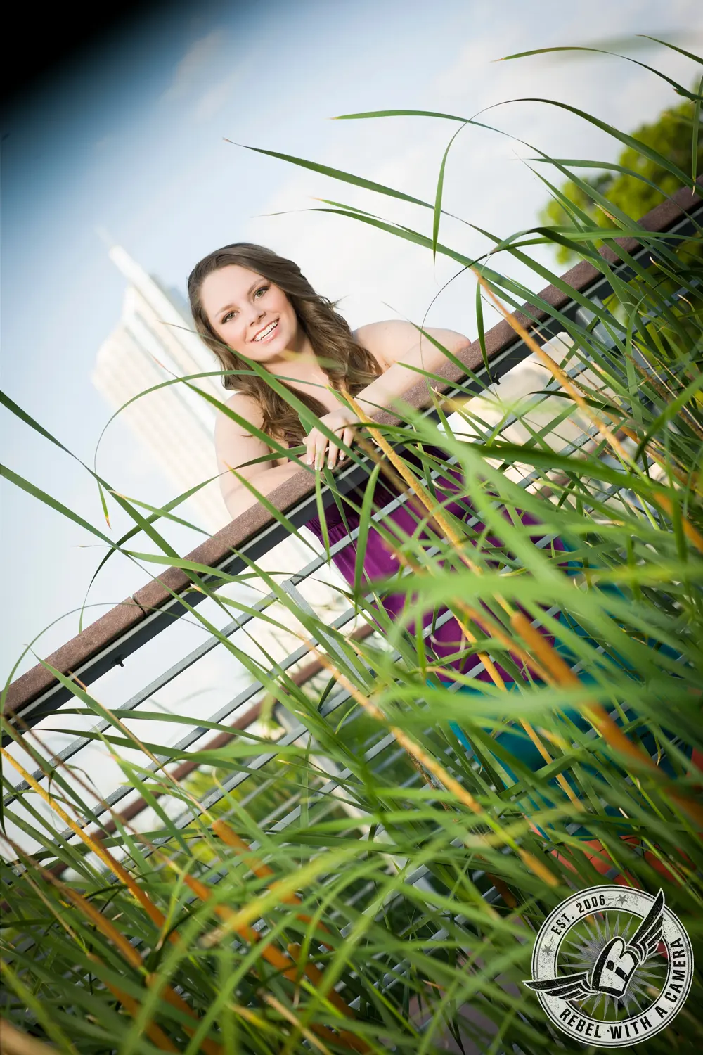 Austin senior portrait of a smiling young woman among tall grasses in Austin, TX.