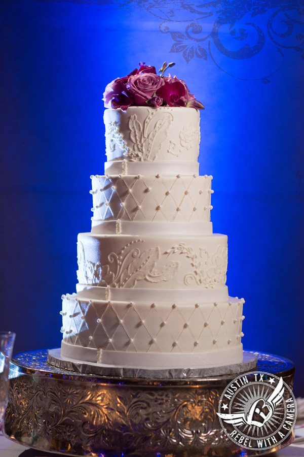 white buttercream wedding cake with blue uplighting