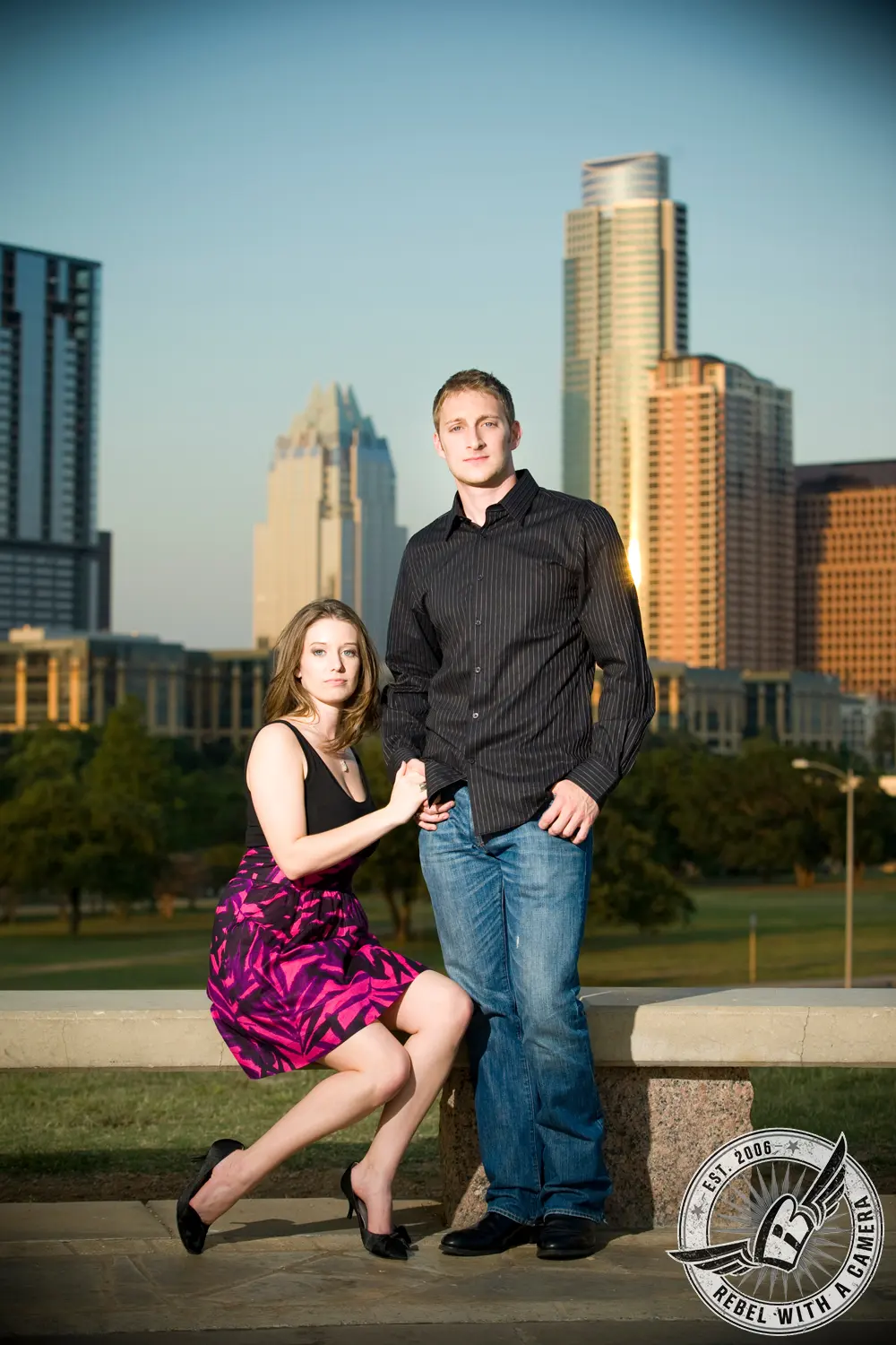 Couple posing in front of the Austin skyline in Austin, TX.