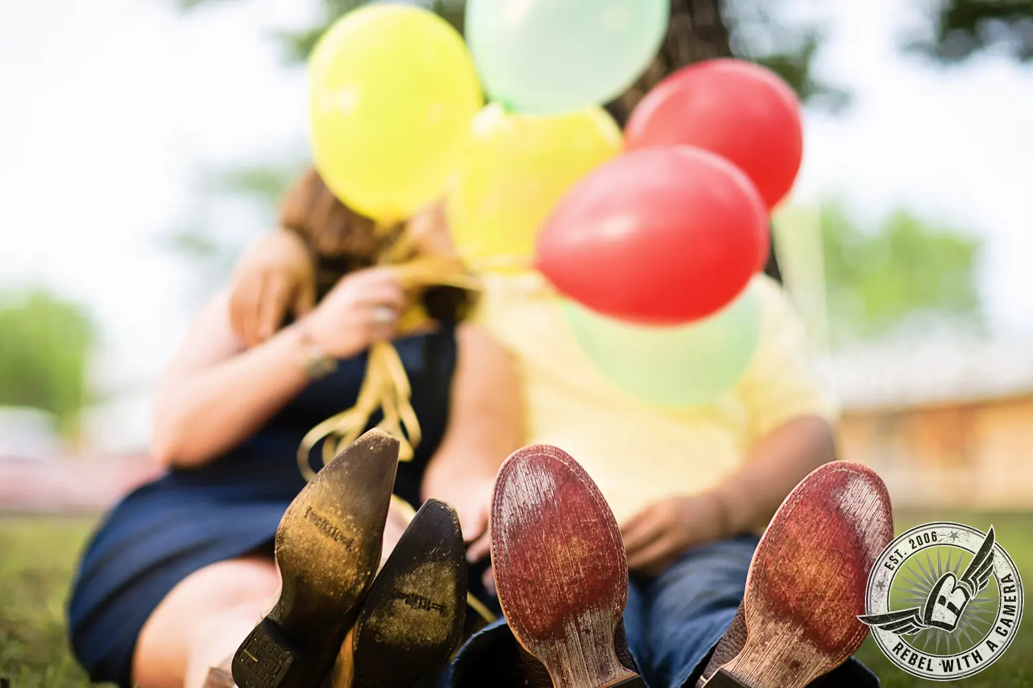 Couple sitting together with colorful balloons in Austin, TX.