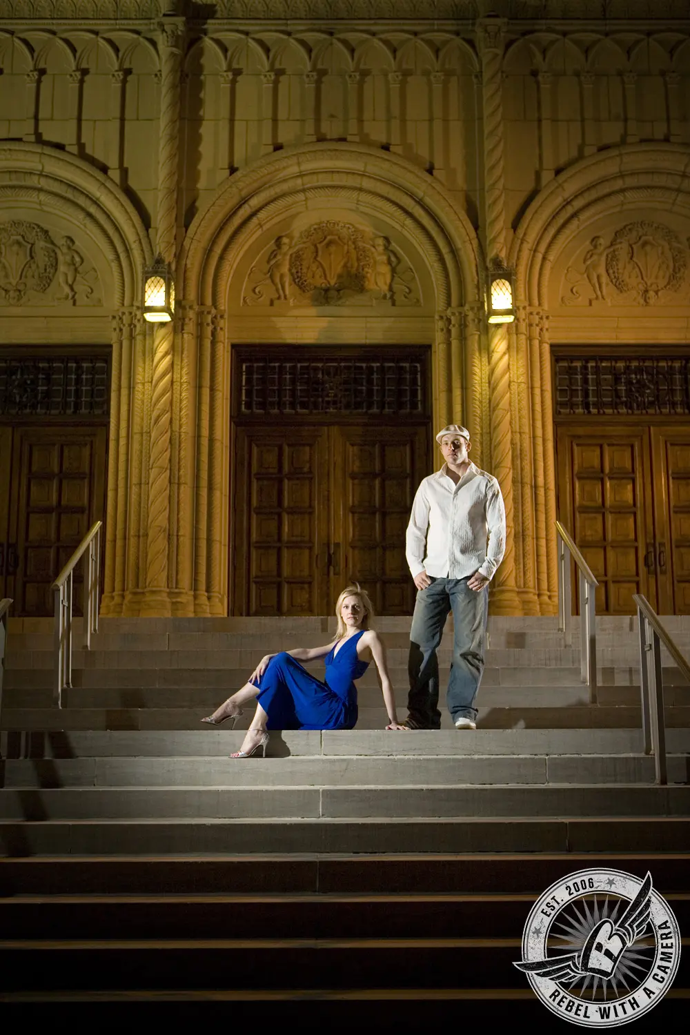 Couple posing on the steps of an ornate building in Austin, TX.