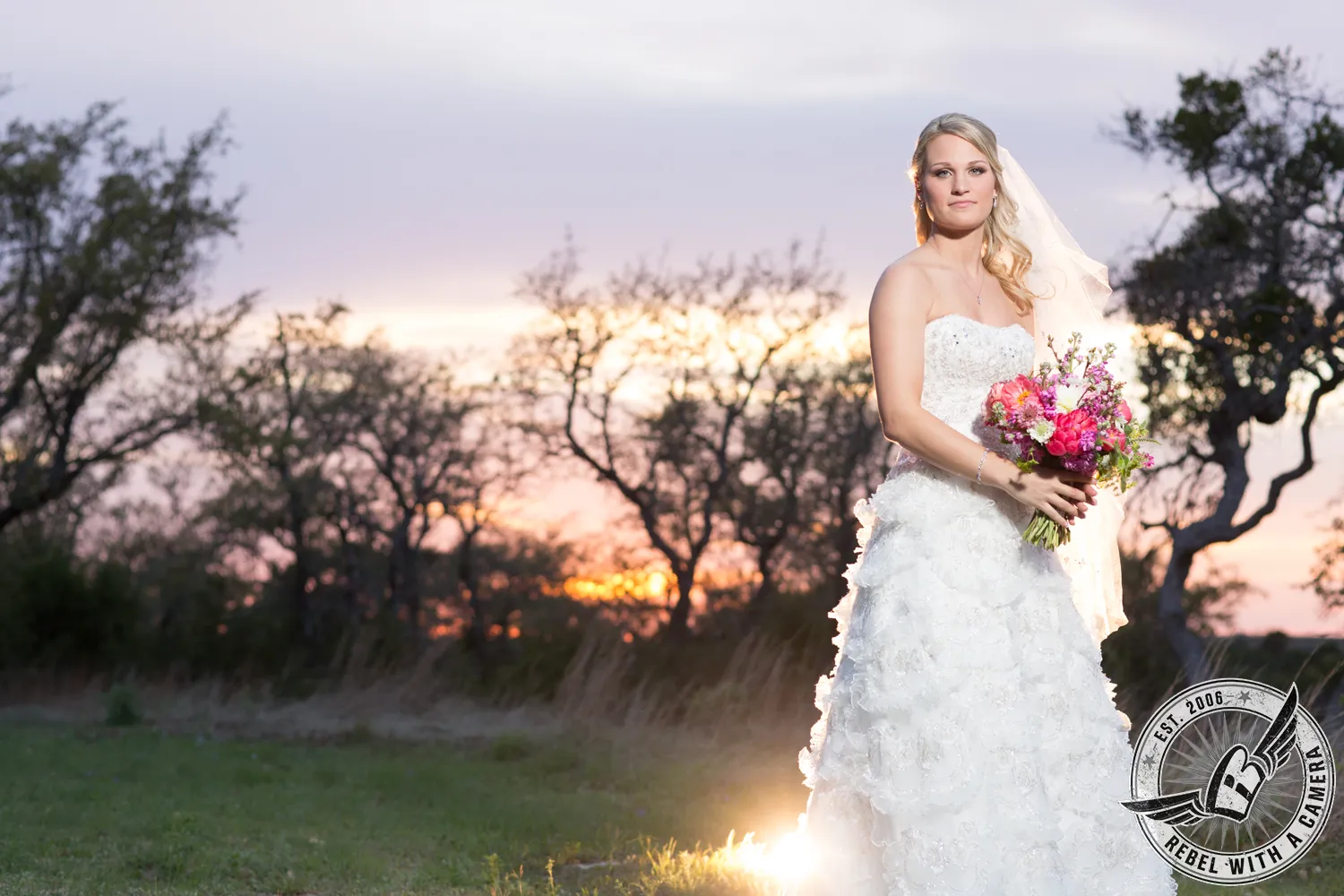 Bride in a white wedding dress holding a bouquet in an outdoor portrait in Austin, TX.