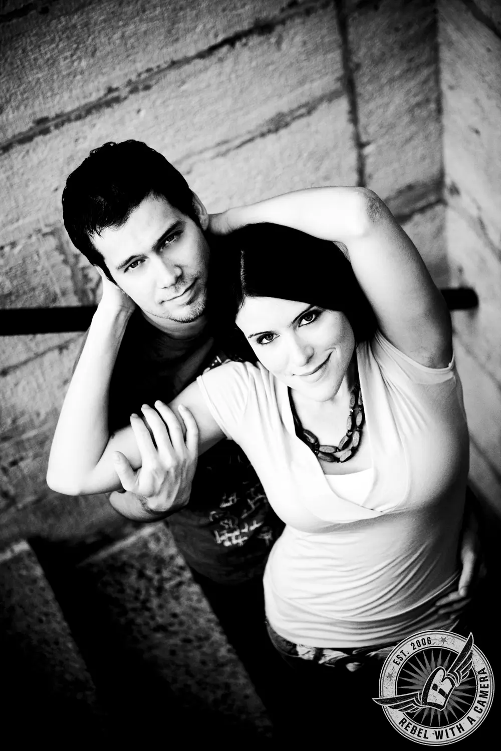 Black and white couple posing closely on a staircase in Austin, TX.