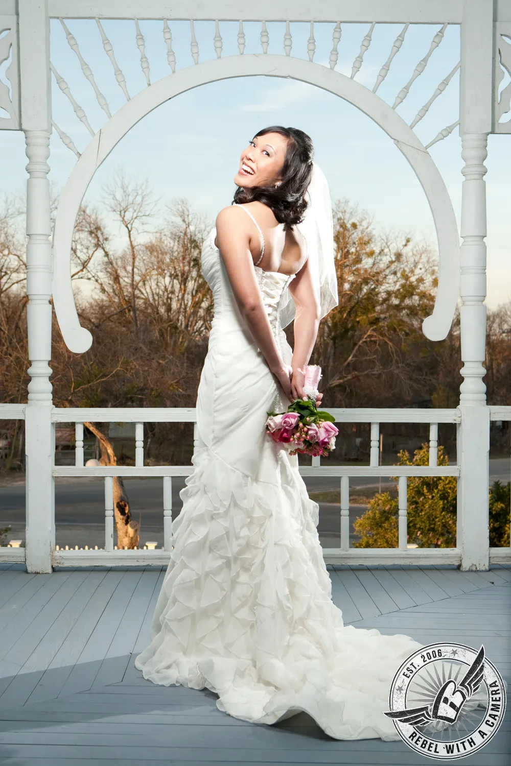 Bride in a white wedding dress standing inside a rustic barn in Austin, Texas.