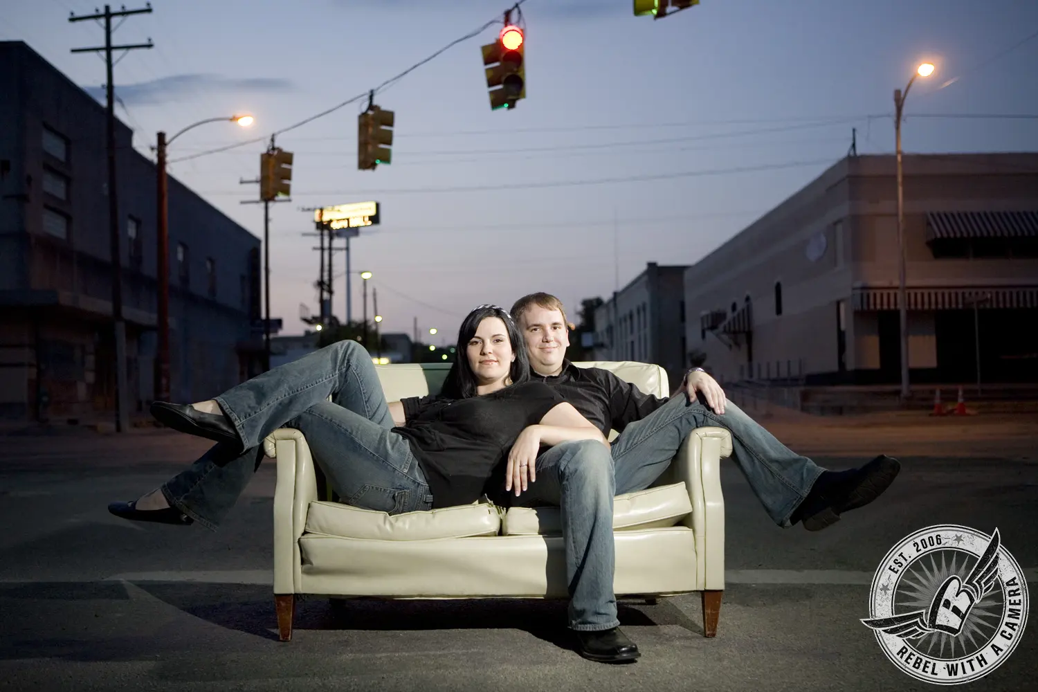 Couple sitting together on a vintage sofa in a city street in Austin, TX.