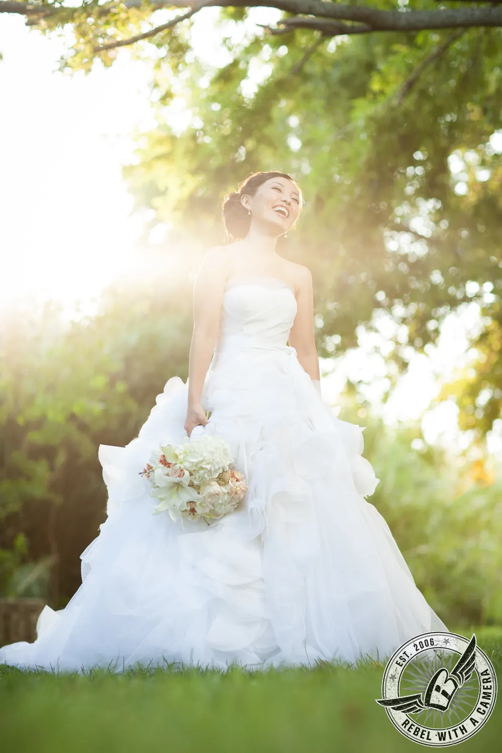 Bride in a white wedding dress holding a bouquet in an outdoor portrait in Austin, TX.