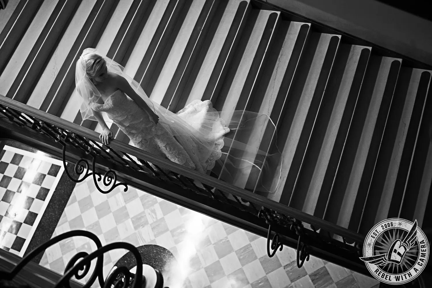 Black-and-white bride descending a dramatic staircase in Austin, Texas.