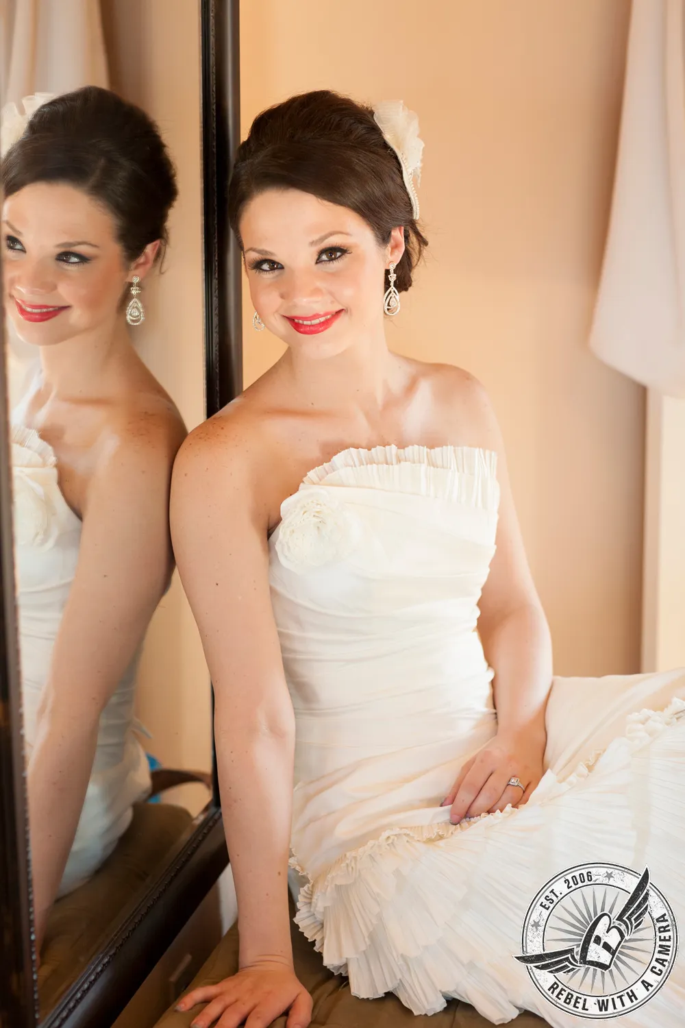 Bride in a white dress seated beside a mirror in Austin, Texas.