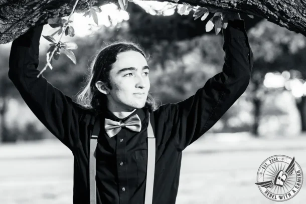 Black and white Alexander senior portrait beneath a tree branch in Austin, TX.