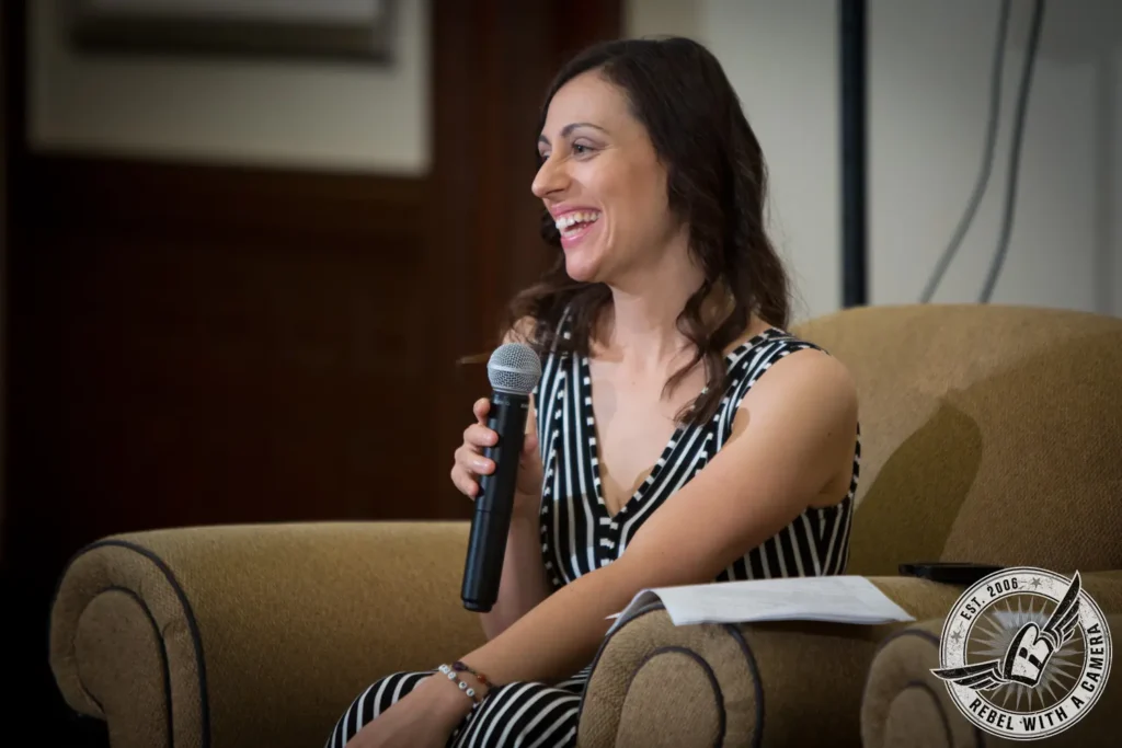Woman holding a microphone during a NEAWP panel in Austin, TX.