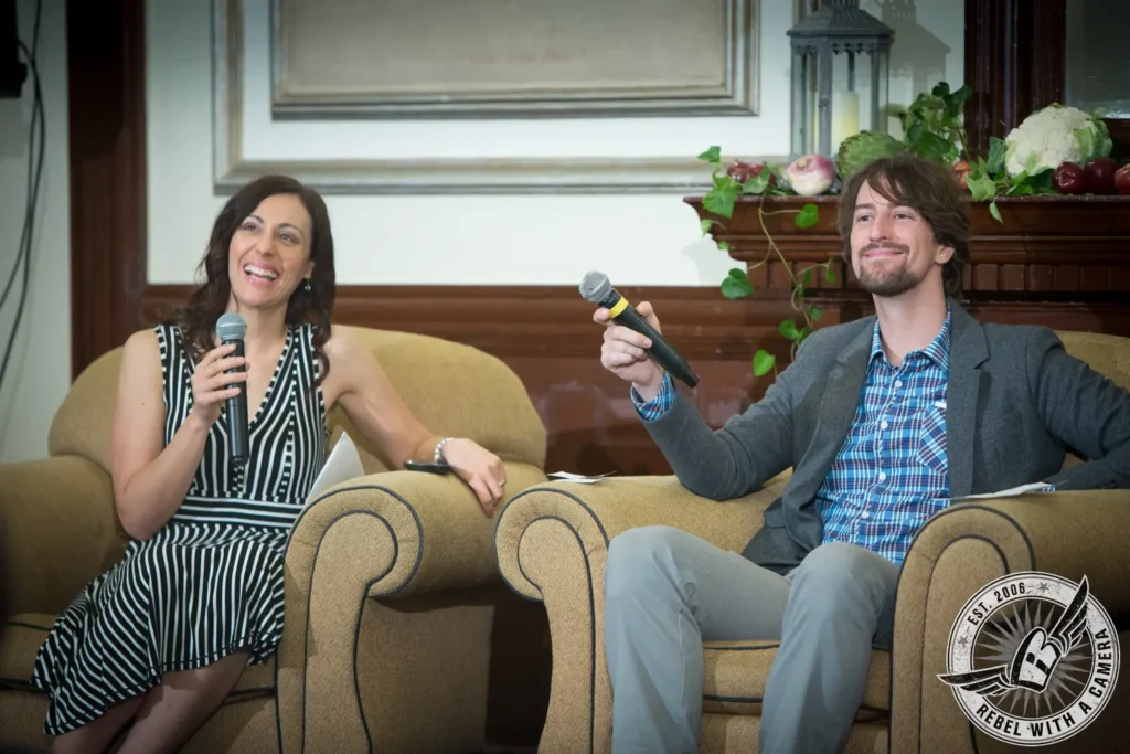 Two speakers holding microphones during a NEAWP meeting