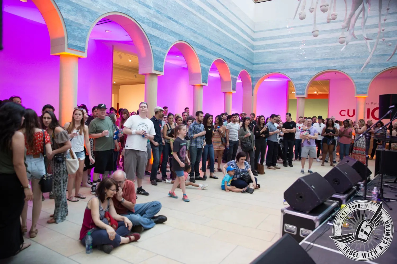 Crowd gathered for live music in a museum atrium in Austin, TX.