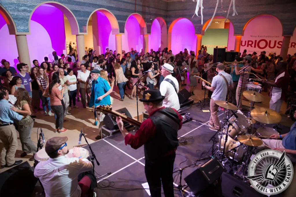 Band performing beneath colorful lights at a museum block party in Austin, TX.