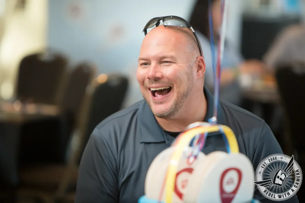Smiling man enjoying a carnival game at Austin Summerfest in Austin, TX.