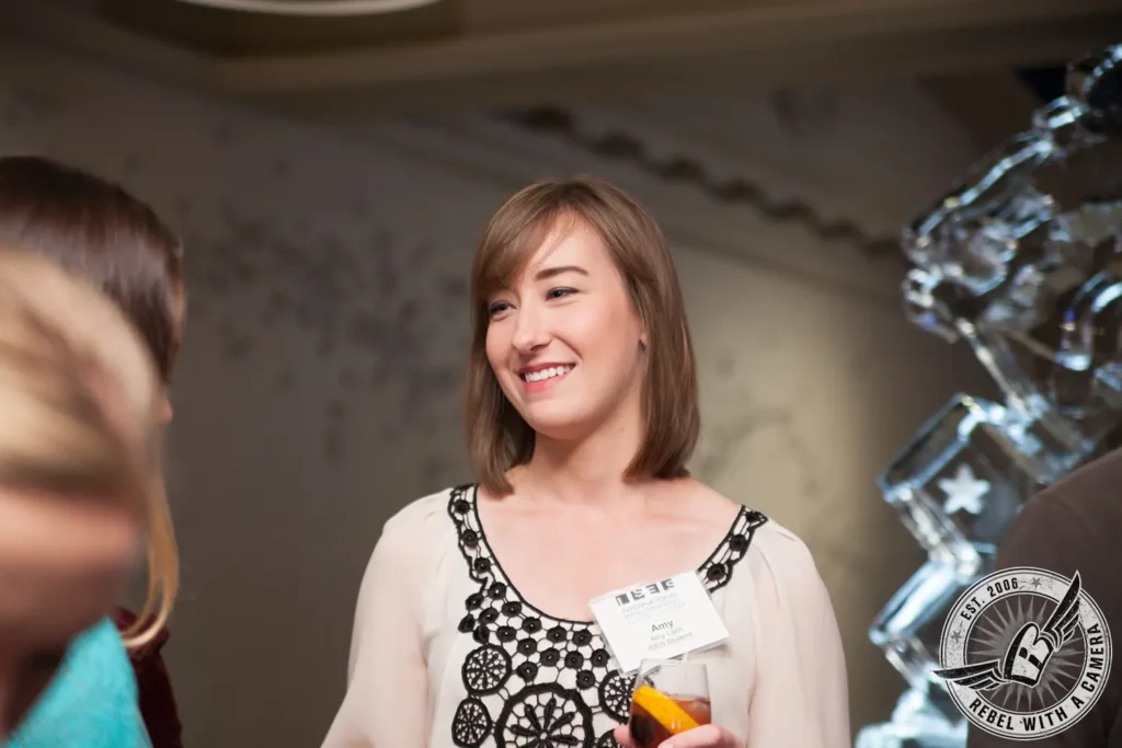 Smiling ISES attendee wearing a name badge at a corporate event in Austin, TX.