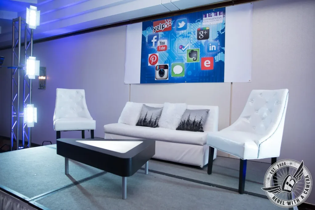 Social media themed event stage with white seating in Austin, TX.