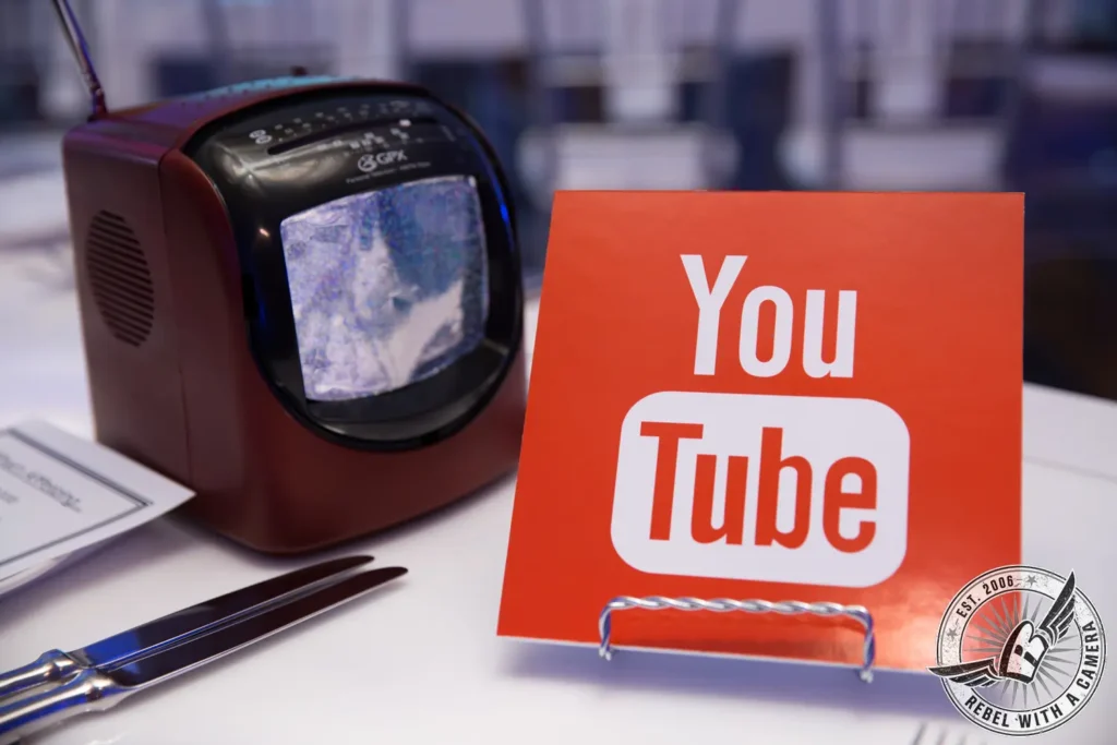 YouTube sign and compact printer at an event media station in Austin, TX.