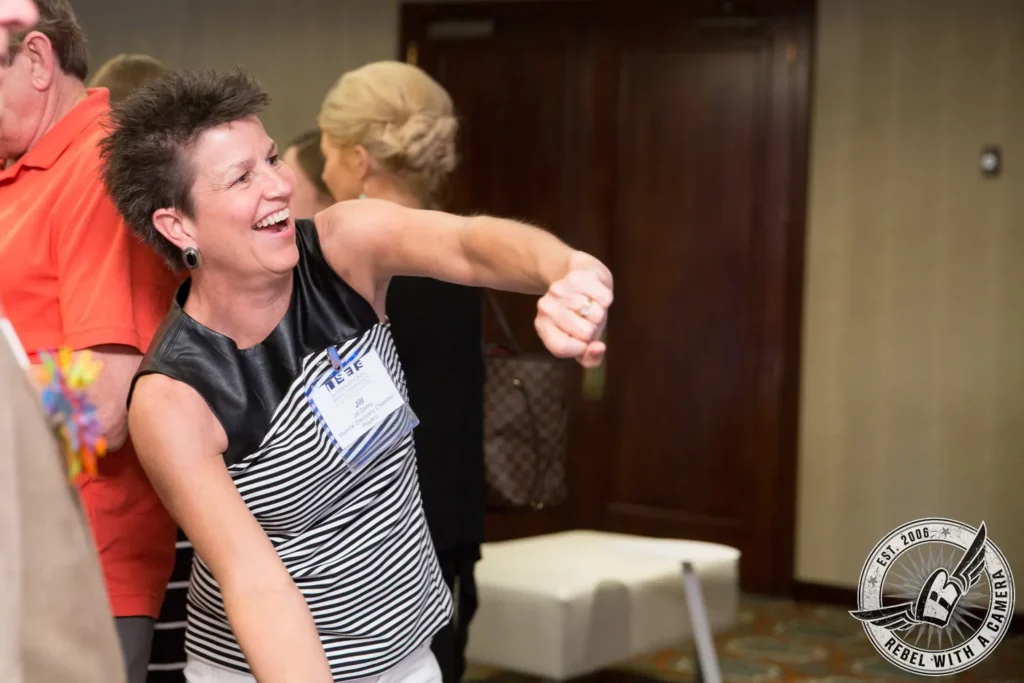 Smiling ISES attendee dancing at a corporate event in Austin, TX.
