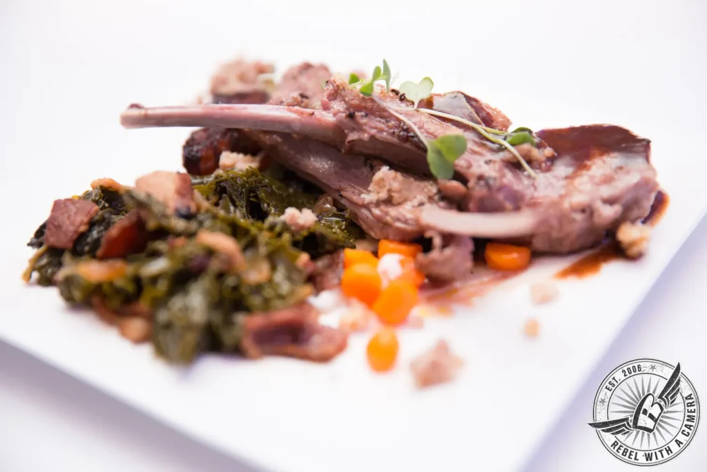 Plated lamb chops with greens and vegetables at an event in Austin, TX.