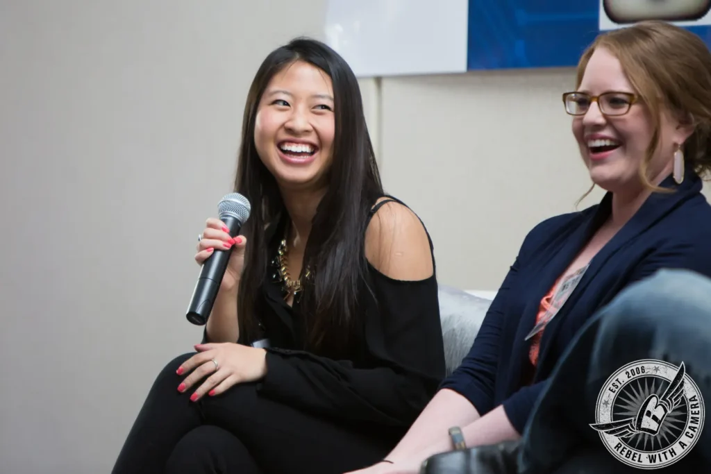 Two women smiling during a panel discussion in Austin, TX.