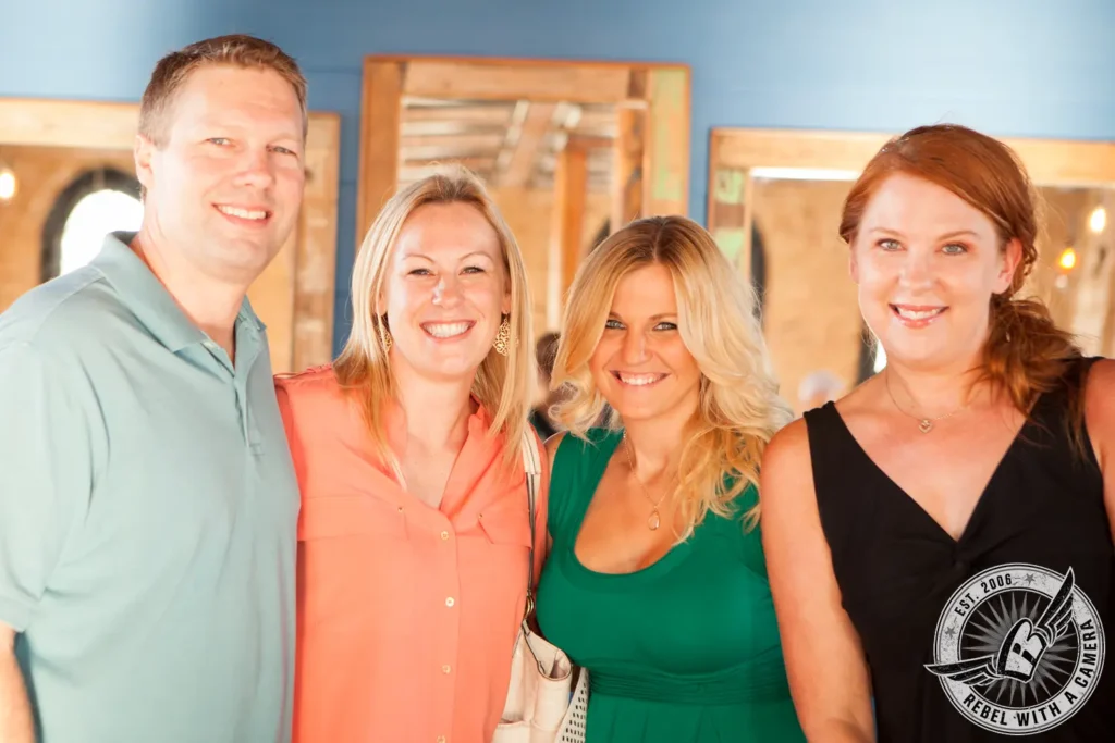 Group of four smiling guests at a corporate event in Austin, TX.