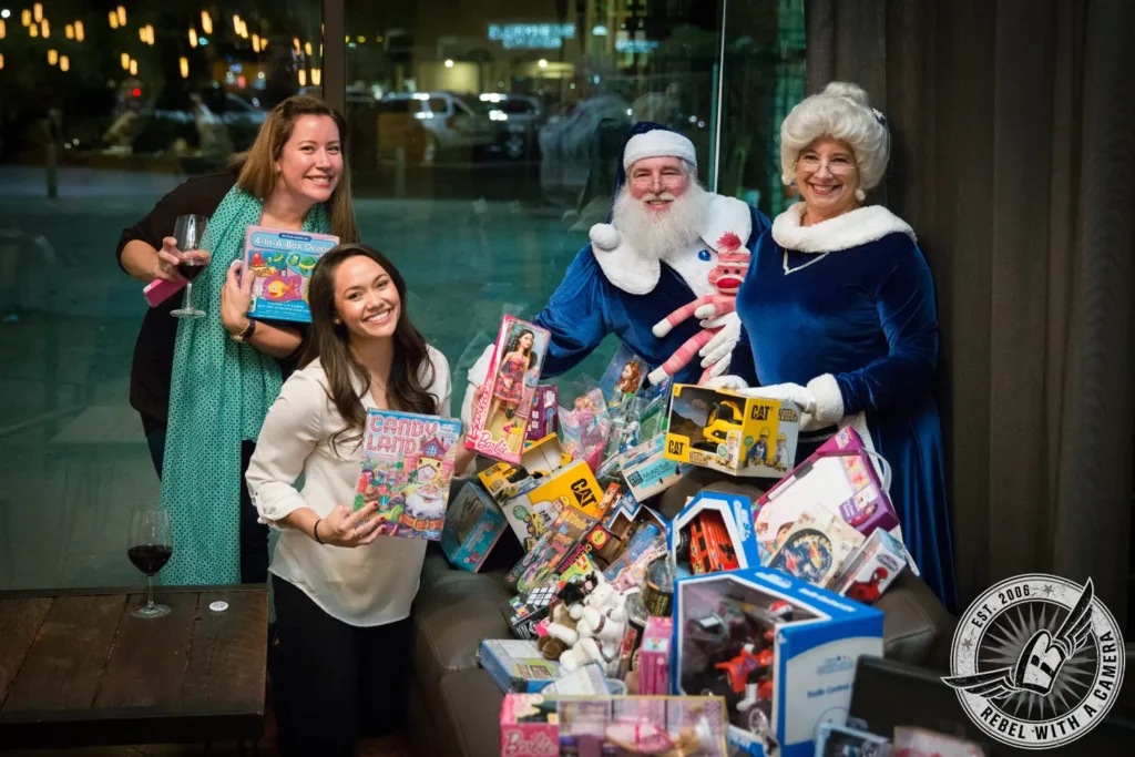 Santa and Mrs. Claus with guests and donated toys in Austin, TX.