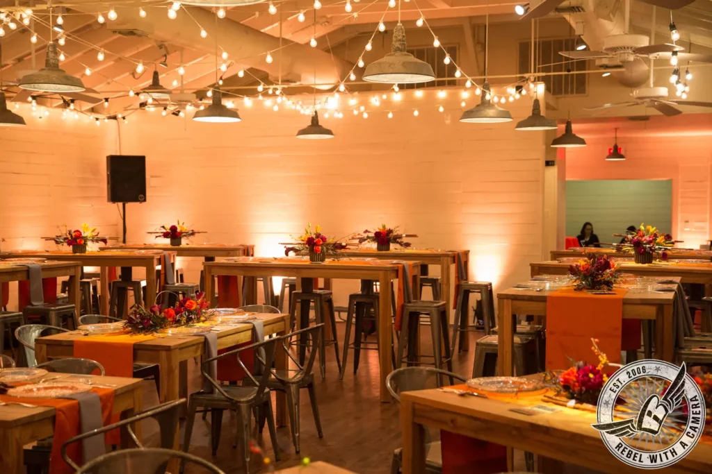 Event dining room with decorated tables and string lights in Austin, TX.