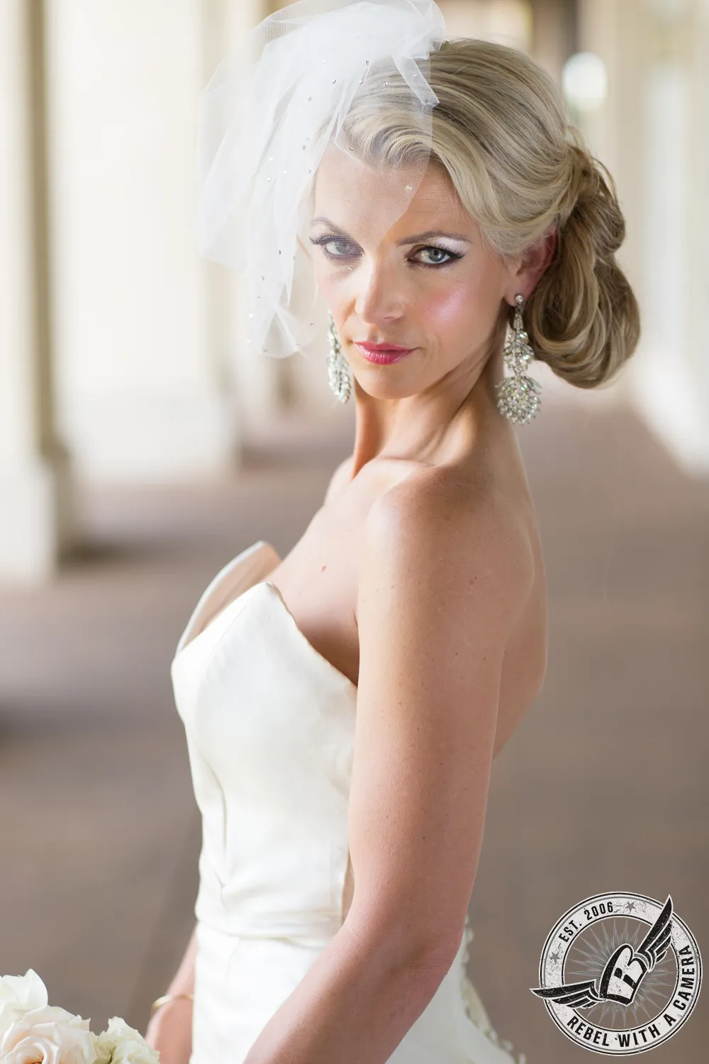 Bride in a white wedding dress and veil posing indoors in Austin, Texas.