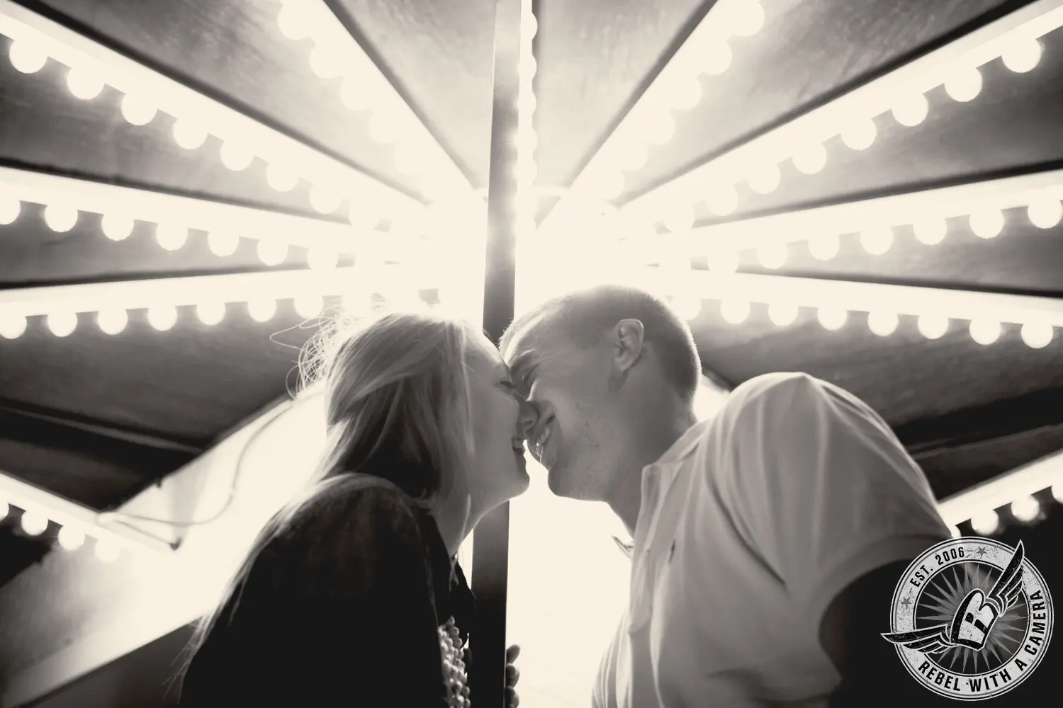 Black and white couple portrait beneath a carousel canopy in Austin, TX.
