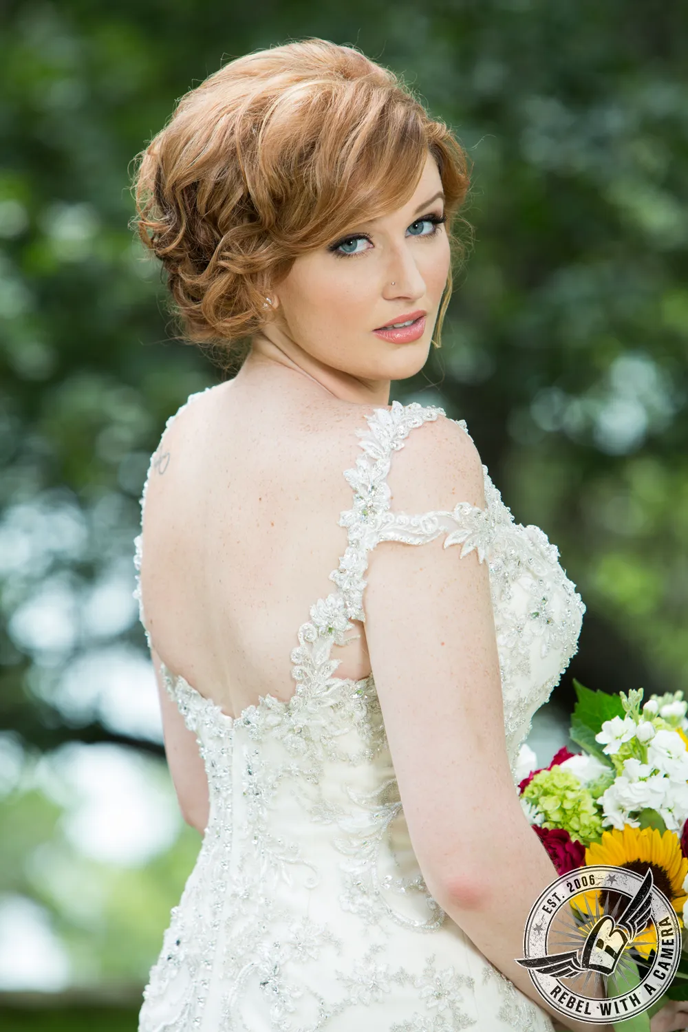 Red-haired bride looking over her shoulder with a bouquet in Austin, TX.