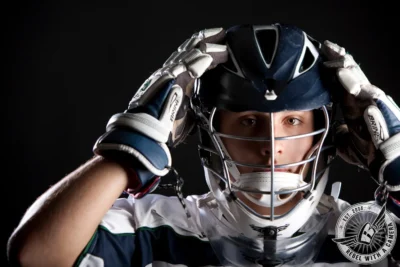close-up hockey senior portrait of a goalie in full protective gear in Austin, TX.