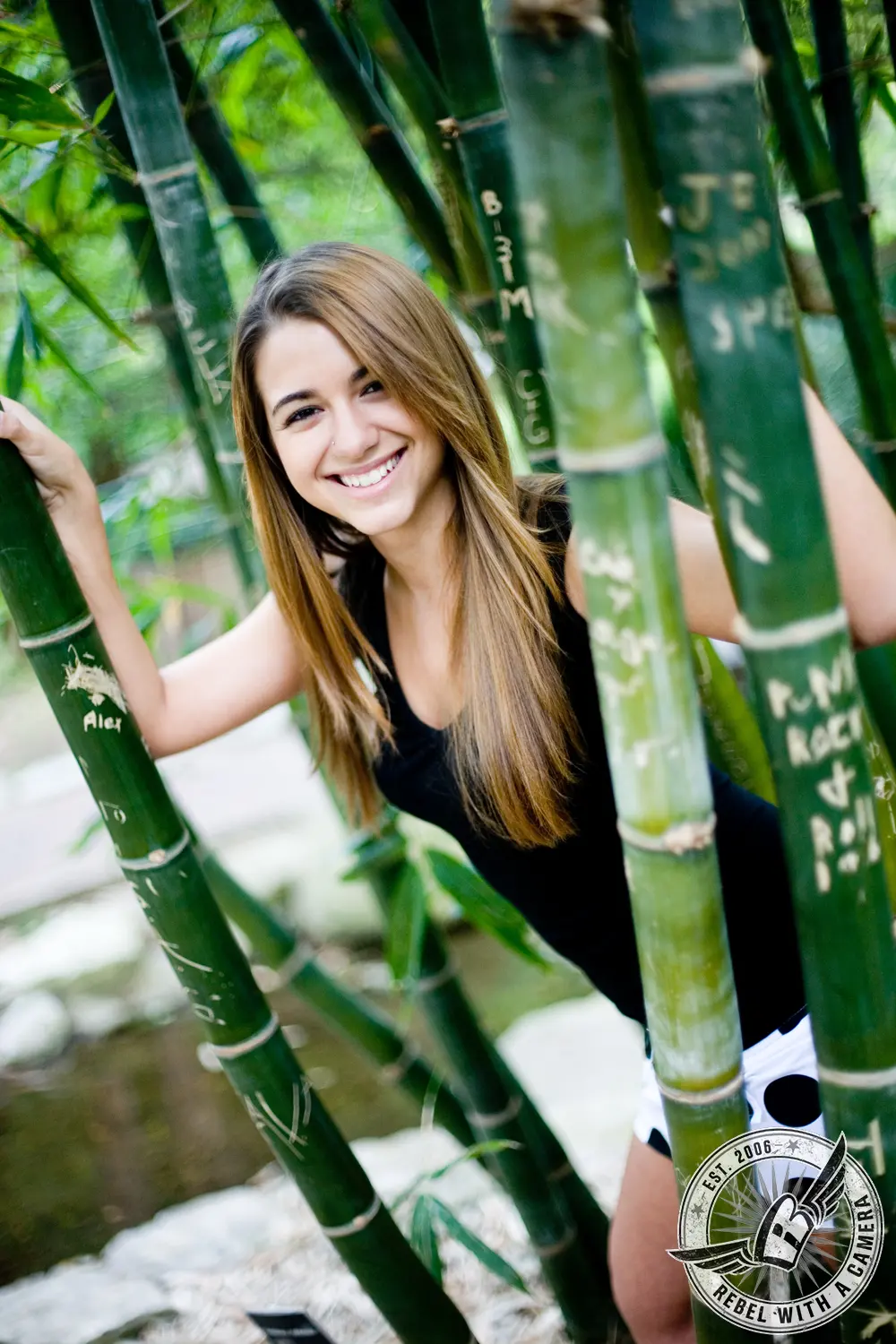 Ruby smiling between tall green bamboo stalks at Zilker Botanical Gardens.
