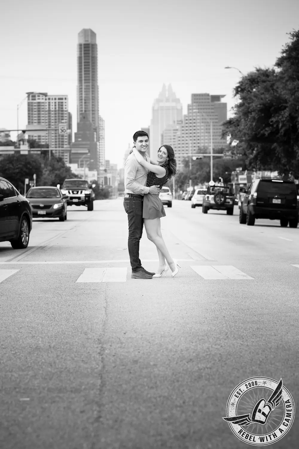 Black and white couple portrait embracing in an Austin street in Austin, TX.